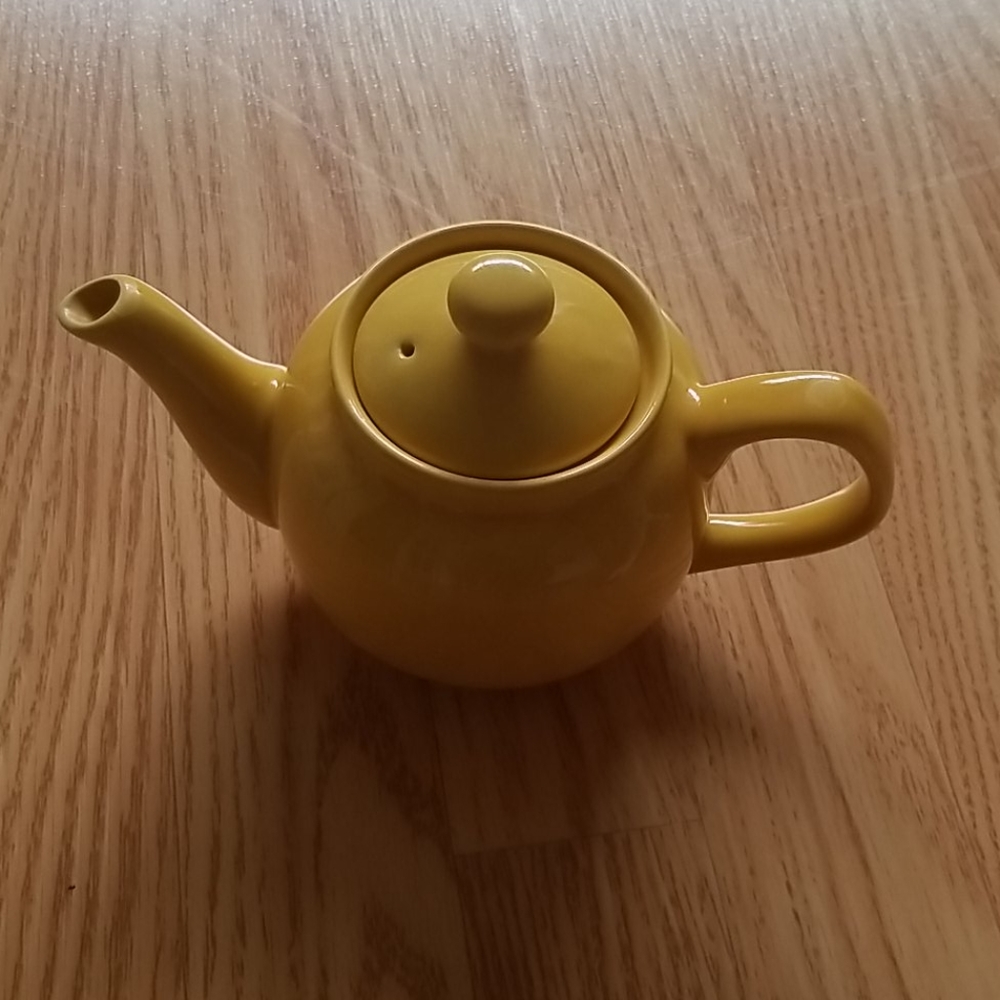Small yellow ceramic teapot